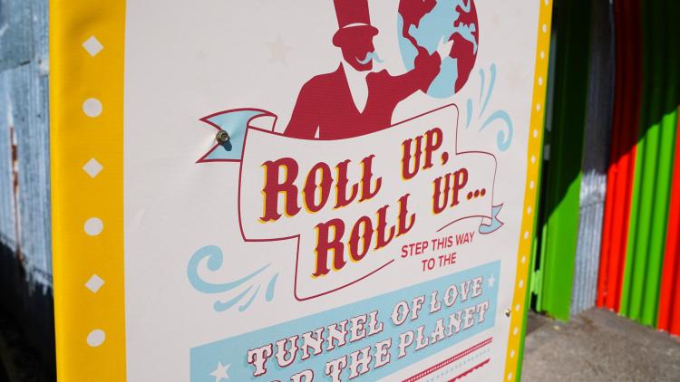 A poster from the Tunnel of Love exhibition which reads 'Roll up, roll up...'