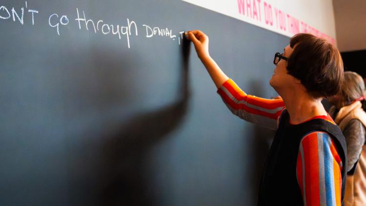 Cornelia Parker writing on chalkboard