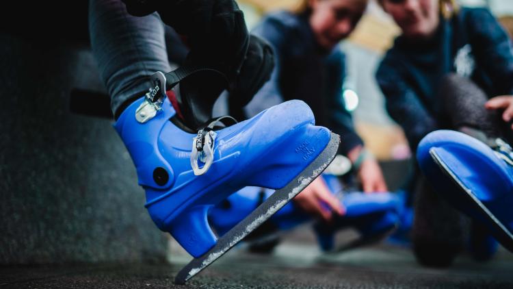 People putting on ice skates