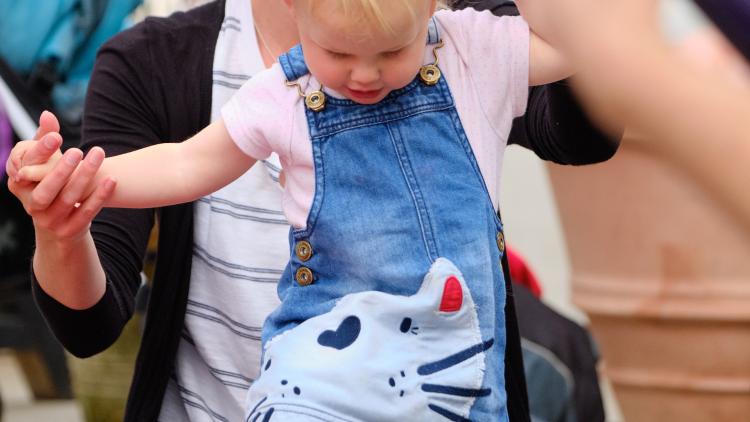 Mum and baby dancing to music in the Med Biome.