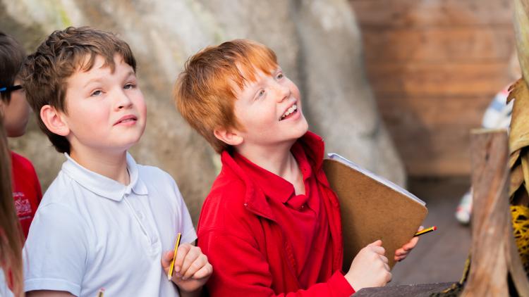 Two school boys exploring the Eden Project with clip boards.