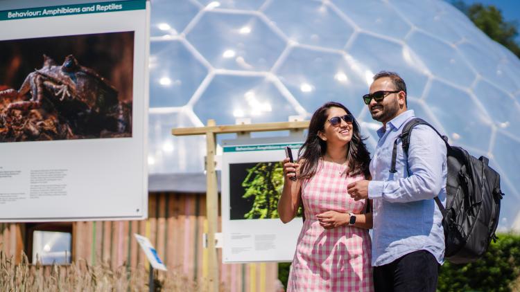 Couple looking at the Wildlife Photographer of the Year exhibition in the Eden Project's Outdoor Gardens