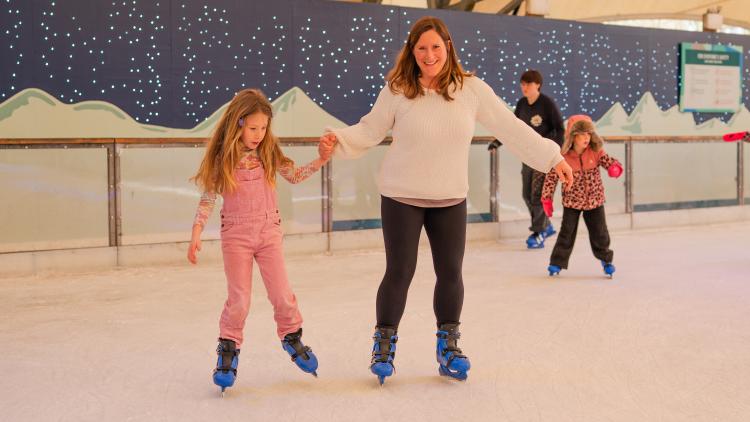 Mother and daughter ice skating at Eden Project