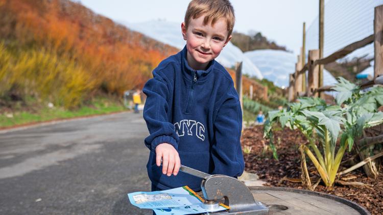 Boy stamping a Scarecrows' Wedding activity sheet