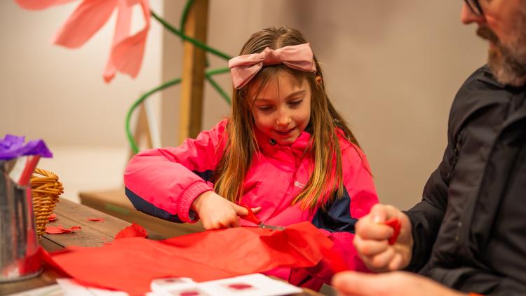 Girl creating craft flowers at Eden Project