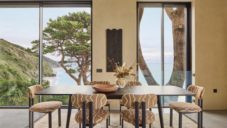 Omaze dining room with views out onto the sea