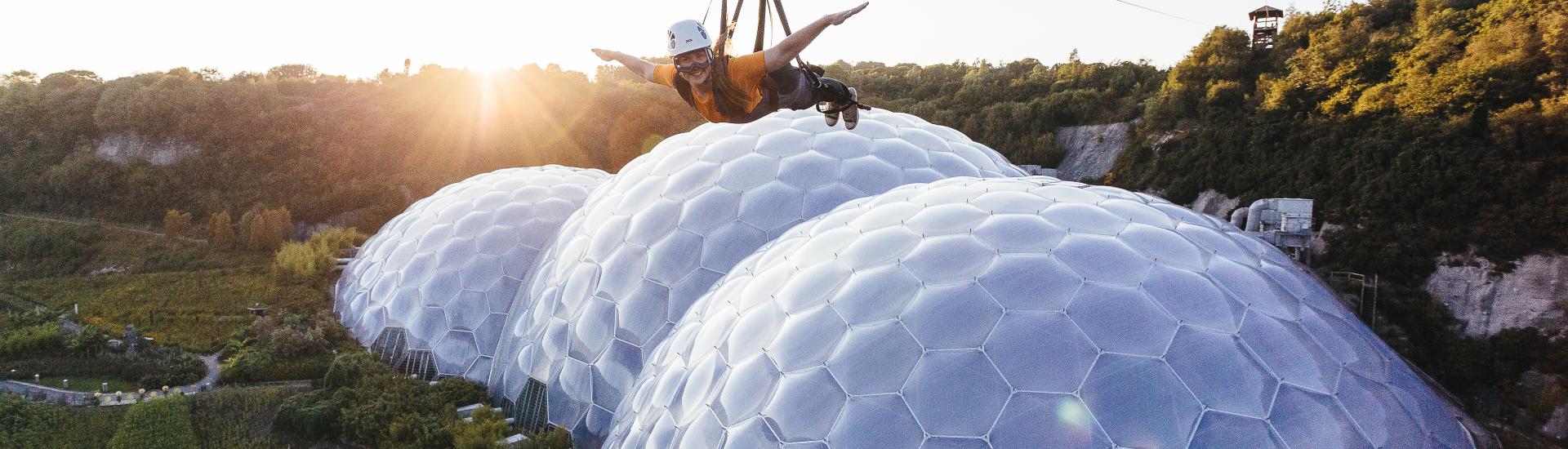 Person on zip wire over Eden Project