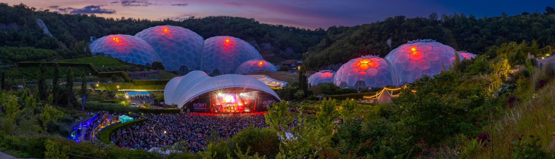 Wide shot of an Eden Sessions concert with purple and orange sky