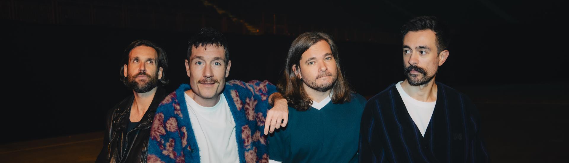 Bastille band sat together