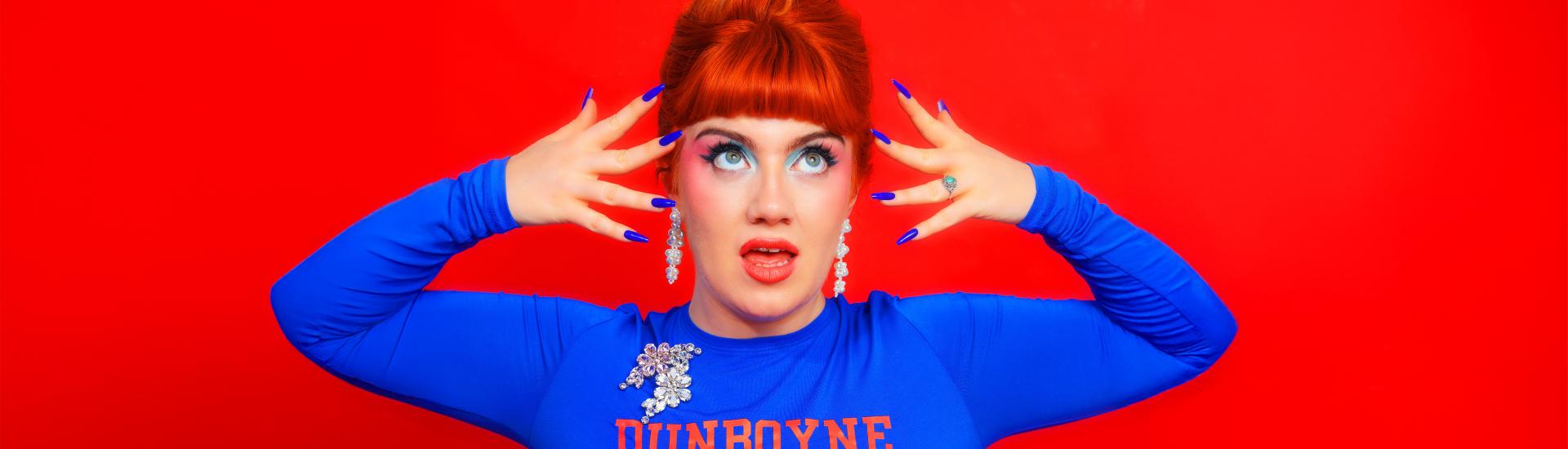 Singer CMAT Stood posing with hands to face